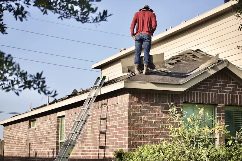 Professional roofer working on a residential roof in Lexington Estates